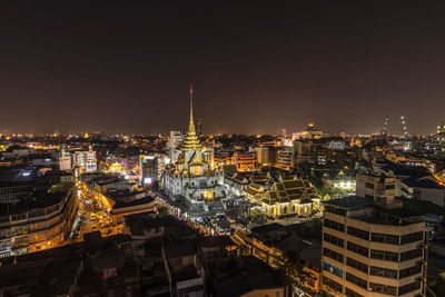 High angle view of illuminated buildings in city at night