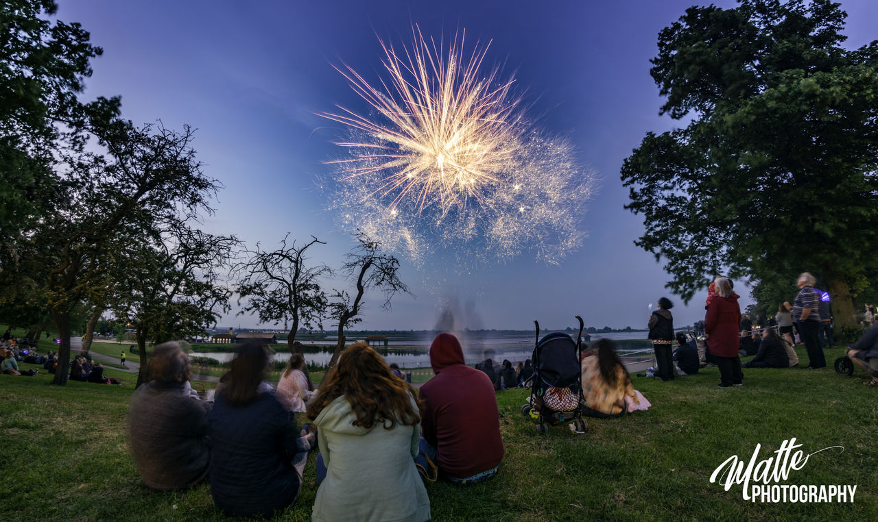 PEOPLE WATCHING FIREWORKS DISPLAY