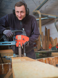 Portrait of man working on machine