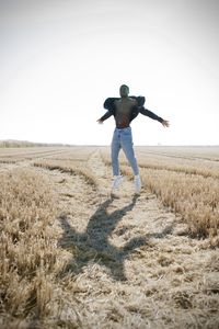 Rear view of man standing on field