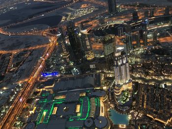 High angle view of city lit up at night