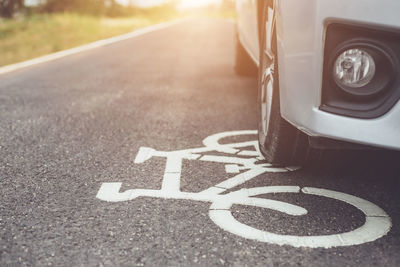 Car on bicycle lane sign on road