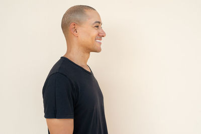 Young man standing against wall