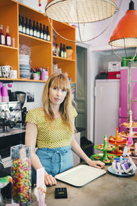 Young woman standing at home