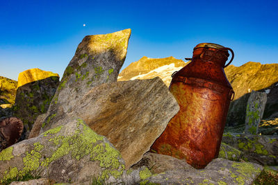 Low angle view of rock formation against blue sky