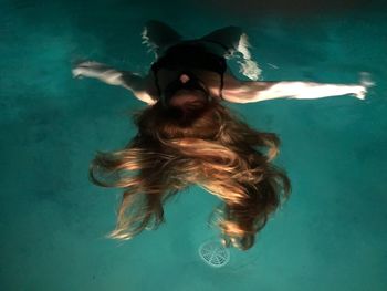 Portrait of woman with dog in swimming pool