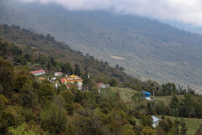 High angle view of trees and buildings against mountains