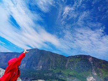 Man standing in mountain against blue sky