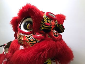 Close-up of multi colored statue on red background