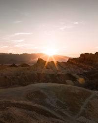 Scenic view of desert against sky during sunset