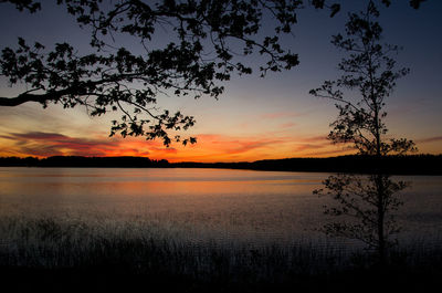 Scenic view of lake against romantic sky at sunset