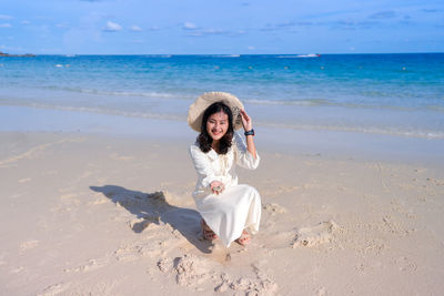 Young woman standing at beach