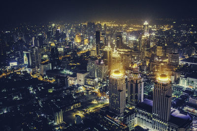 High angle view of illuminated city buildings at night