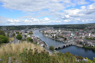 High angle view of river amidst buildings against sky