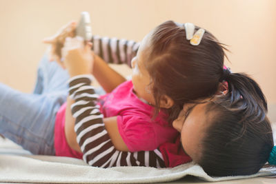 Rear view of girl holding woman