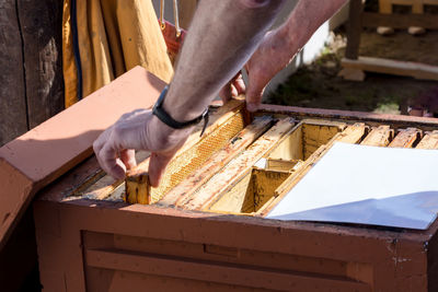 Low section of man working on wood