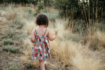 Full length of girl walking on field