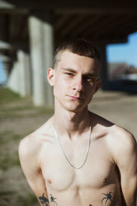 Portrait of shirtless man standing outdoors