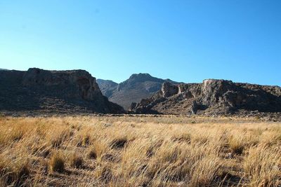 Scenic view of mountains against clear blue sky