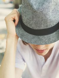 Midsection of woman holding hat