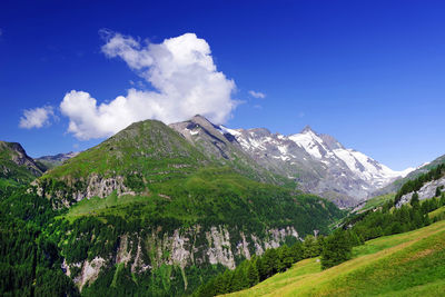 Scenic view of mountains against blue sky