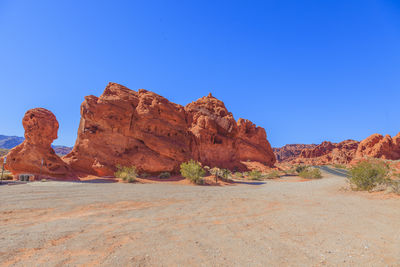 Rock formations in desert against clear blue sky