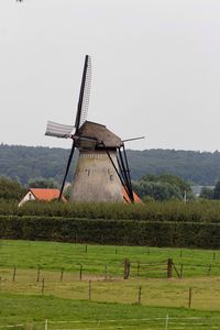 Traditional windmill on field