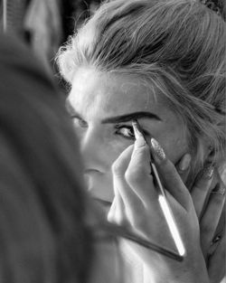 Close-up of woman applying eyebrow at home