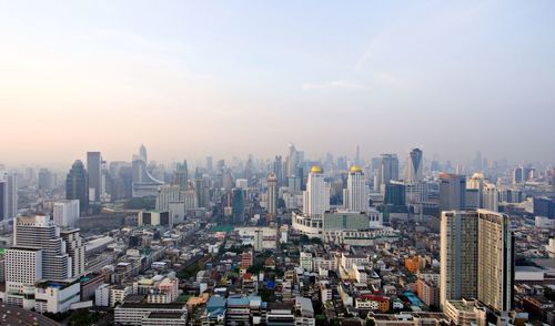 Aerial view of modern buildings in city against sky