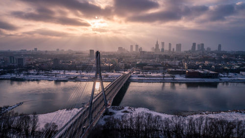 View of city at waterfront during sunset