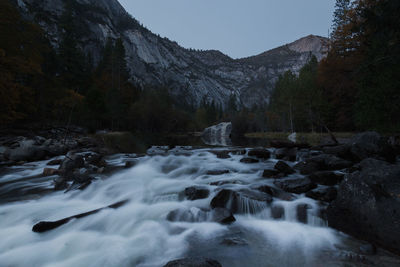 Scenic view of waterfall against sky