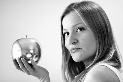 Close-up portrait of young woman over white background