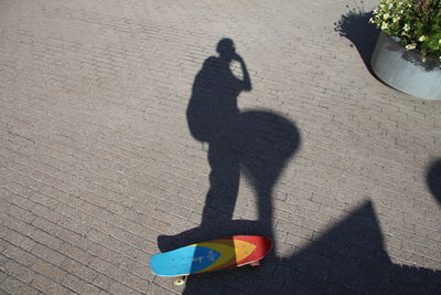 Shadow of people on street in city