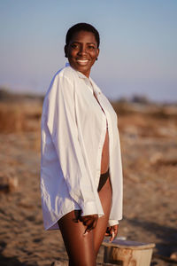 Portrait of beautiful woman standing on beach