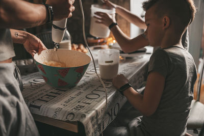 Midsection of woman holding food on table