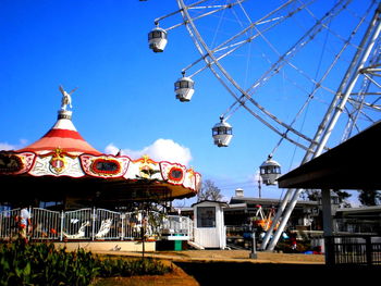 Low angle view of illuminated lights against blue sky