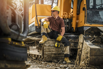 Construction worker sitting on bulldozer