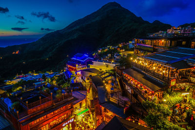 High angle view of illuminated buildings in city at night