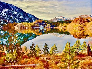 Scenic view of lake and mountains against sky