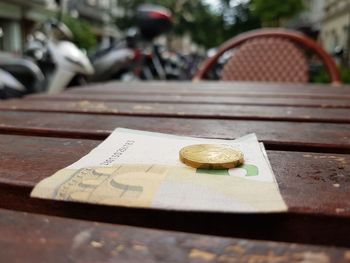 Close-up of money on table at sidewalk cafe