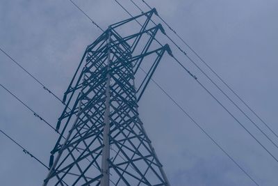 Low angle view of electricity pylon against sky