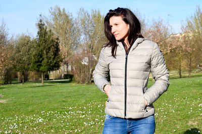 Young woman standing on grassy field