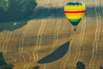 Hot air balloon flying over lake