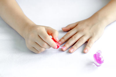 Cropped hands of woman with nail polish