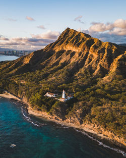 Scenic view of sea and mountains against sky