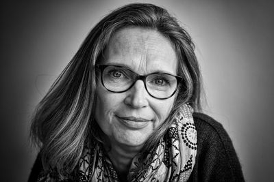 Close-up portrait of smiling mature woman wearing eyeglasses