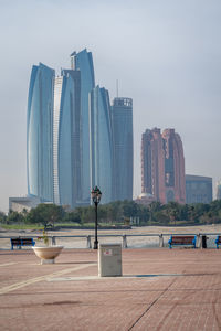 Modern buildings in city against clear sky