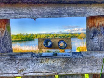 Scenic view of river against sky seen through window