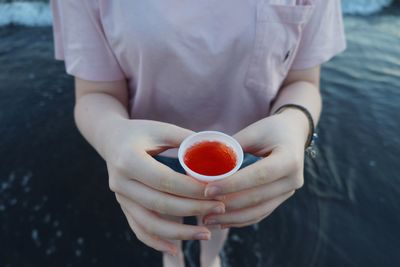 Close-up of hand holding ice cream
