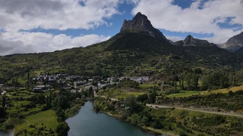 Scenic view of river and mountains against sky